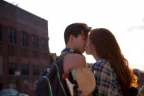 Young couple kissing outdoors — Stock Photo