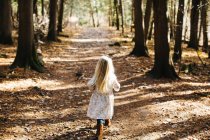 Back view of Blond haired girl in forest — Stock Photo