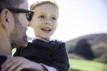 Father and son enjoying day outdoors — Stock Photo