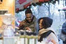 Romantic happy couple enjoying city during winter holidays at outdoor market — Stock Photo