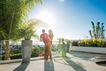 Couple looking at view from penthouse rooftop garden, La Jolla, California, USA — Stock Photo