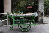 Green cart parked in market, Bangkok, Thailand — Stock Photo
