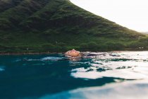Swimmer floating on surface of sea — Stock Photo