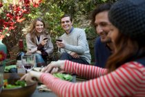 Friends eating together outdoors — Stock Photo