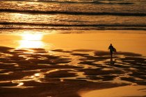 Surfer on beach in Cornwall, UK — Stock Photo