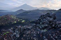 Lava field and Tolbachik Volcano — Stock Photo