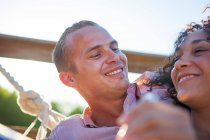 Young couple smiling together on balcony, close up — Stock Photo
