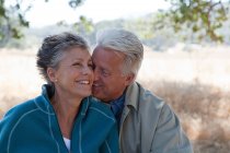 Loving mature couple outdoors in forest — Stock Photo