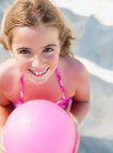 Young girl with ball smiling at viewer — Stock Photo
