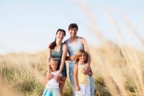 Family smiling at the beach — Stock Photo