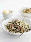 Dish of pesto pasta with tomatoes and fork — Stock Photo