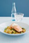 Тарелка жареной рыбы с овощным гарниром и соусом — стоковое фото