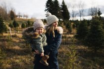 Mother and baby girl in Christmas tree farm, Cobourg, Ontario, Canada — Stock Photo