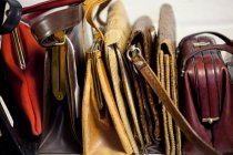 Closeup shot of handbags placed in row on white background — Stock Photo