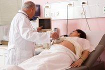 Pregnant woman having ultrasound scan — Stock Photo