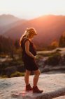 Pregnant woman in mountains touching stomach, Sequoia national park, California, USA — Stock Photo