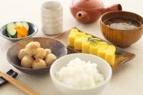 Still life of japanese dumplings, omelette and soup — Stock Photo
