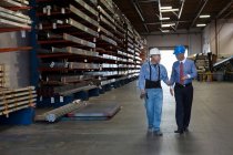 Worker and businessman in metal plant — Stock Photo
