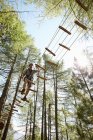 Person doing treetop obstacle course — Stock Photo