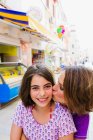 Mother kissing daughter outdoors — Stock Photo