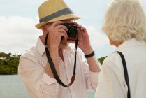 Senior homem fotografando esposa — Fotografia de Stock