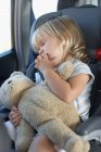 Young girl sleeping in a car — Stock Photo
