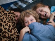 Mother and children in a tent — Stock Photo