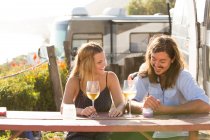 Couple having wine together outdoors — Stock Photo