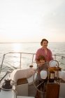 Father and son steering yacht — Stock Photo