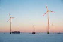 Windmills in winter landscape with sunrise sky — Stock Photo