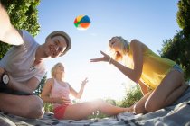 Pov of friends playing with beach ball in park — Stock Photo
