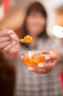 Woman offering spoonful of preserves, close-up partial view, selective focus — Stock Photo