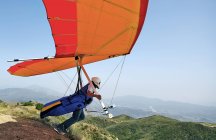 Hang glider pilot taking off — Stock Photo