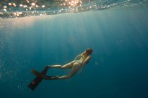 Frau mit Schwimmflossen schwimmt unter Wasser, Oahu, Hawaii, USA — Stockfoto