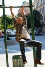Mittlerer erwachsener Mann hängt an Laternenpfahl — Stockfoto