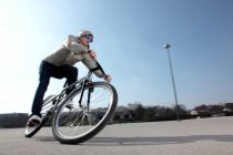 Mid adult cyclist riding bike — Stock Photo