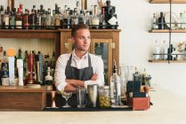 Portrait of bartender behind cocktail bar — Stock Photo