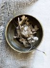 Top view of dried flowers in bowl on burlap — Stock Photo