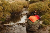 Father and son sitting on rock beside creek, father teaching son to fish, Mineral King, Sequoia National Park, California, USA — Stock Photo