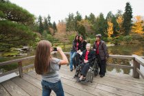 Girl photographing multi generation family — Stock Photo
