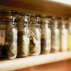 Ktchen glass jars with herbs and spices — Stock Photo