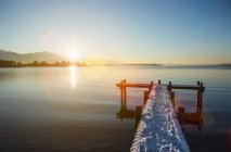 Snowy pier over lake — Stock Photo