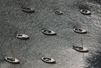 Aerial view of lake with moored boats in sunlight — Stock Photo