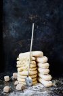 Stack of biscuits and spoon on tabletop on black background — Stock Photo