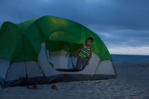 Menino na tenda em Huntington Beach, Califórnia, EUA — Fotografia de Stock