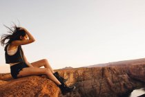 Женщина расслабляется и наслаждается видом, Подкова изгиба, Пейдж, Аризона, США — стоковое фото