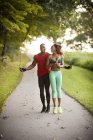 Young couple training on path skipping in unity — Stock Photo