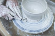 Cape Town, South Africa, carefully applying shape of bowl in ceramic workshop — Stock Photo