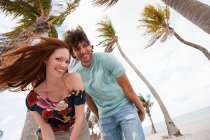 Portrait of young couple resting on beach — Stock Photo