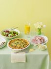 Plates with quiche, ham and salad — Stock Photo